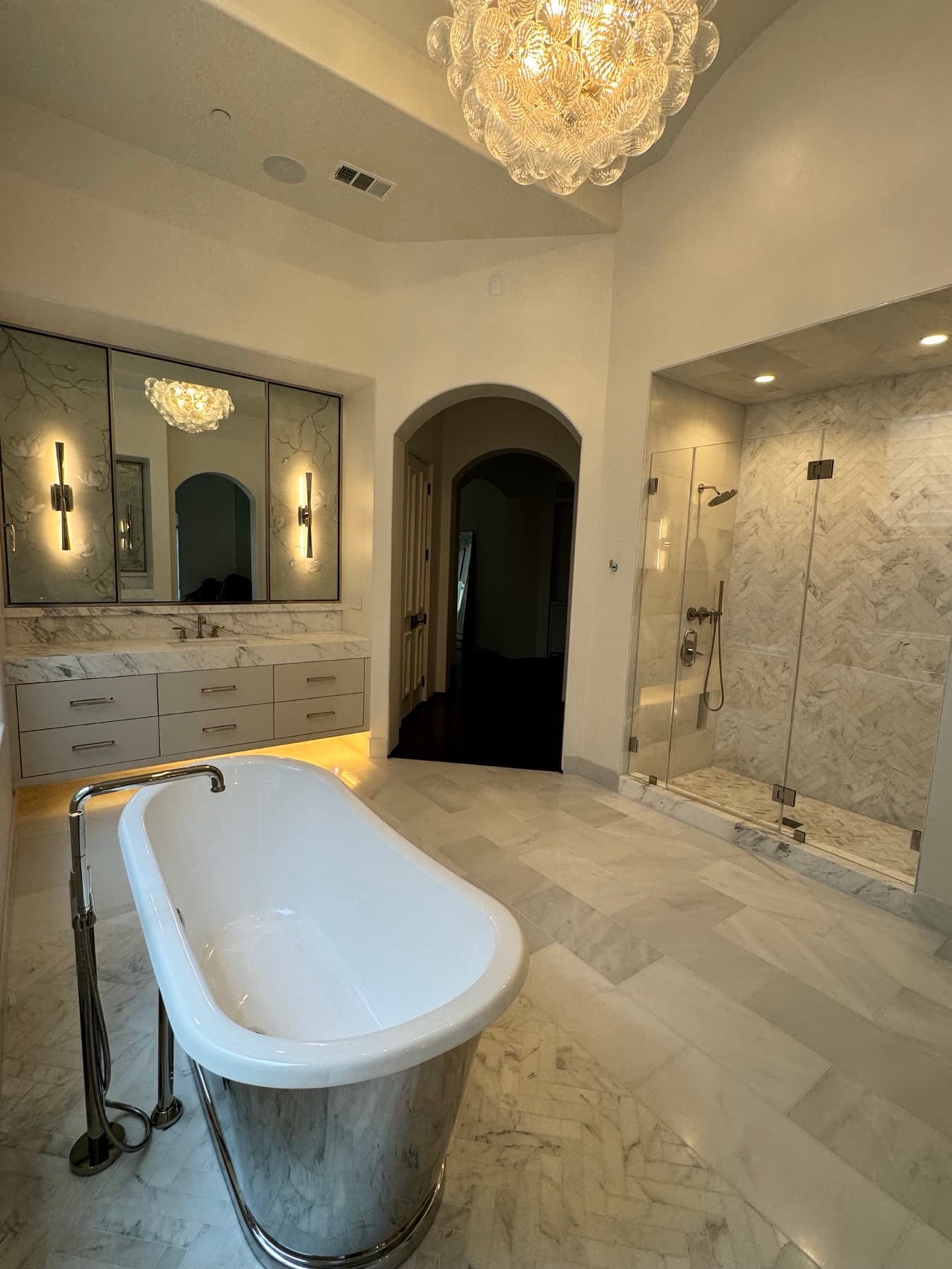 Master bath vanity with backlit mirrors and a warm under-cabinet LED glow