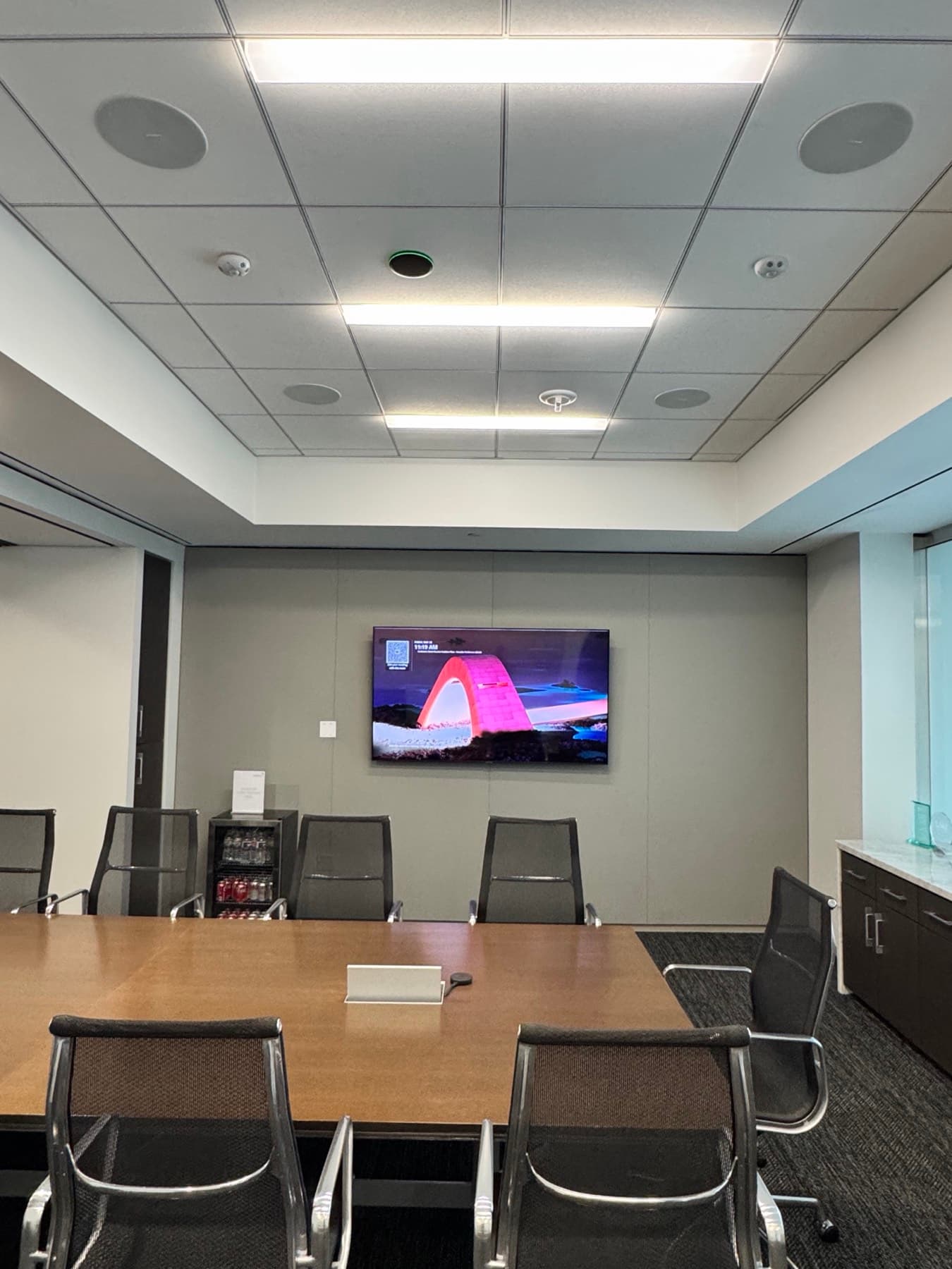 Commercial meeting room with a wall display and in-ceiling speakers