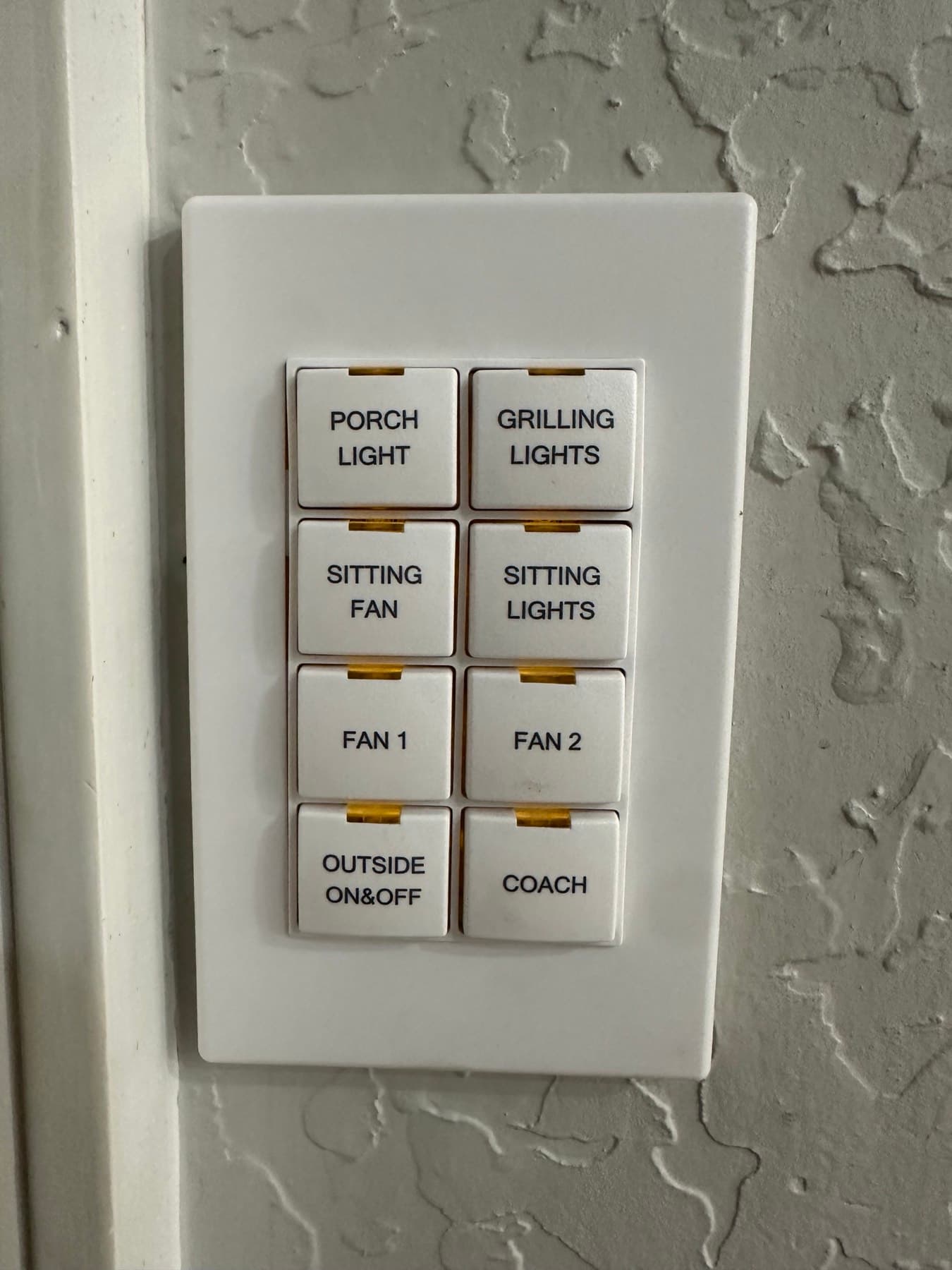 Custom-engraved wall keypad controlling porch, patio, and fan lighting scenes