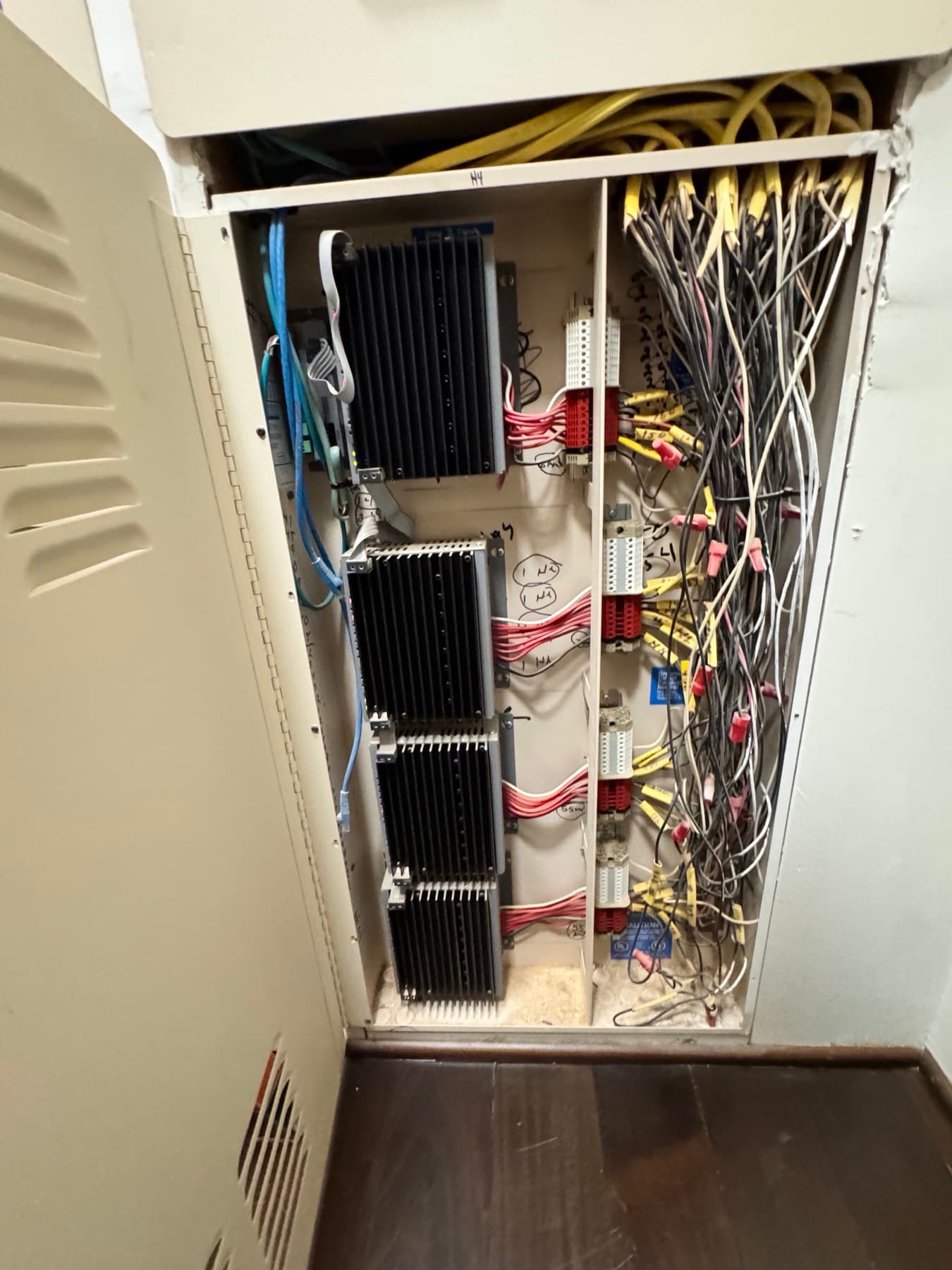 Open centralized lighting control panel with dimming modules and wiring